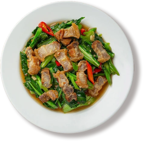 Stir fried kale spicy crispy pork wooden table thai food concept